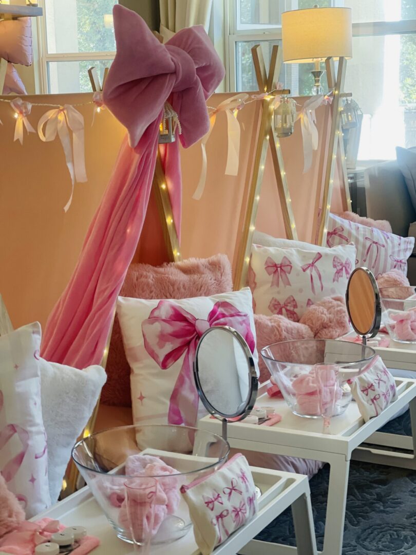 Pink-themed sleepover tents with mirrors and pillows.