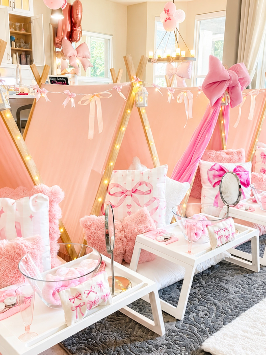 Pink-themed indoor tent sleepover party setup.