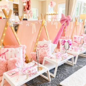 Pink-themed indoor sleepover party setup.
