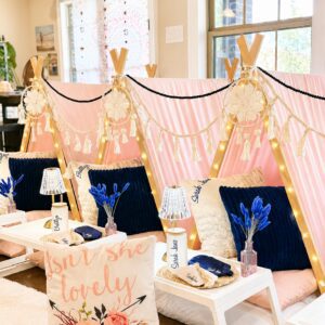 Indoor pink tent setup with decorative pillows.