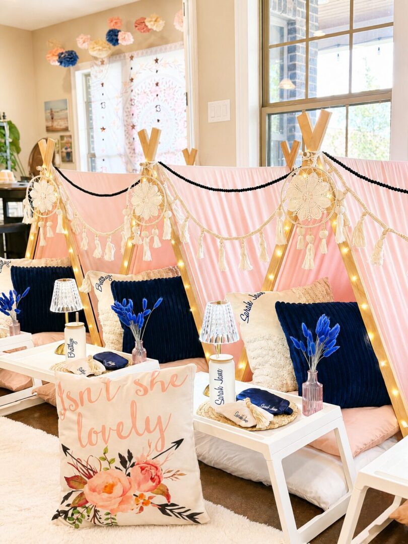 Indoor pink tent setup with decorative pillows.