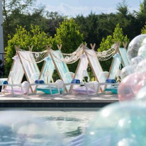 Colorful outdoor tents by a poolside.
