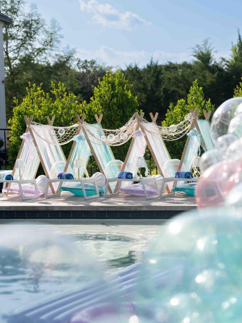 Colorful outdoor tents by a poolside.