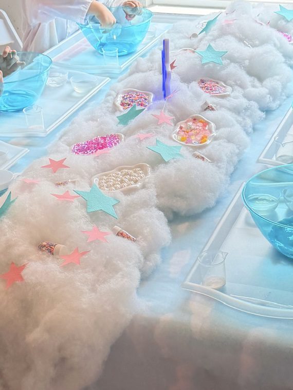 Craft table with cotton and star decorations.