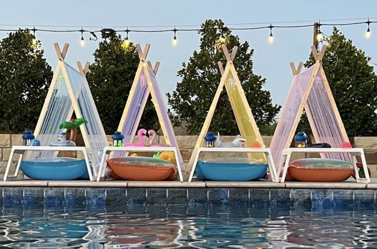 Colorful tents and pools by the water.
