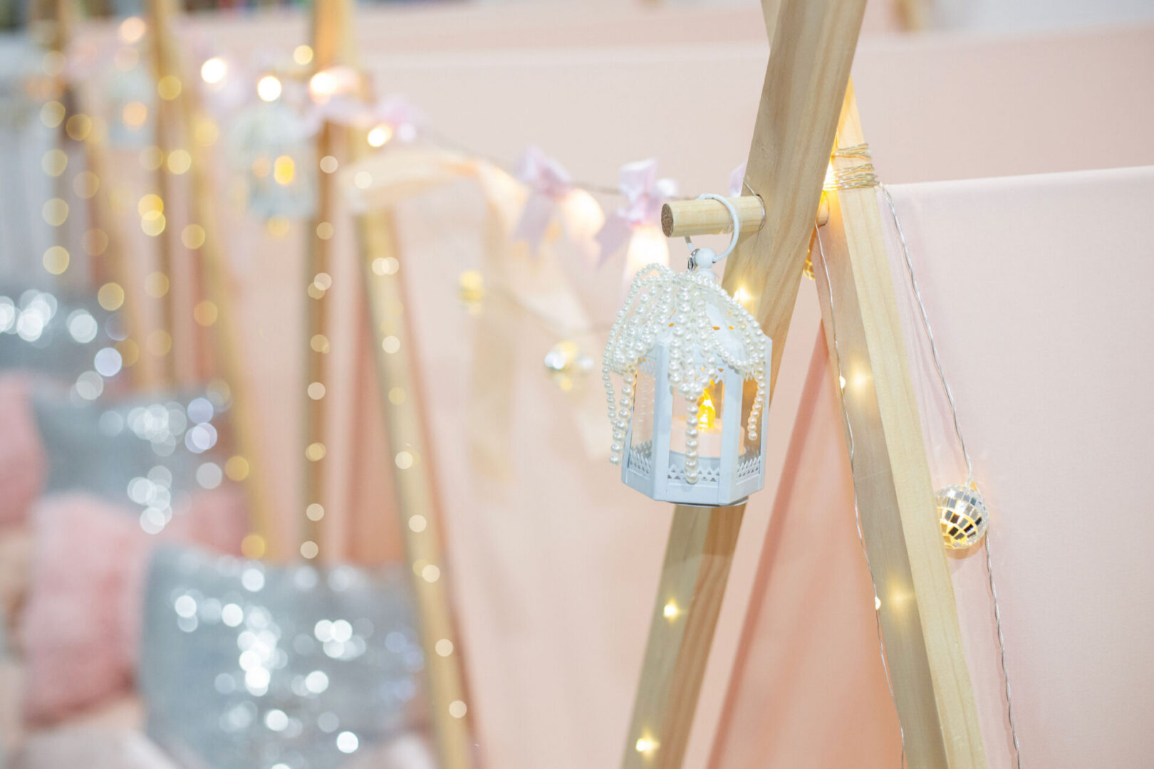 Decorative lanterns on pink tent structure.