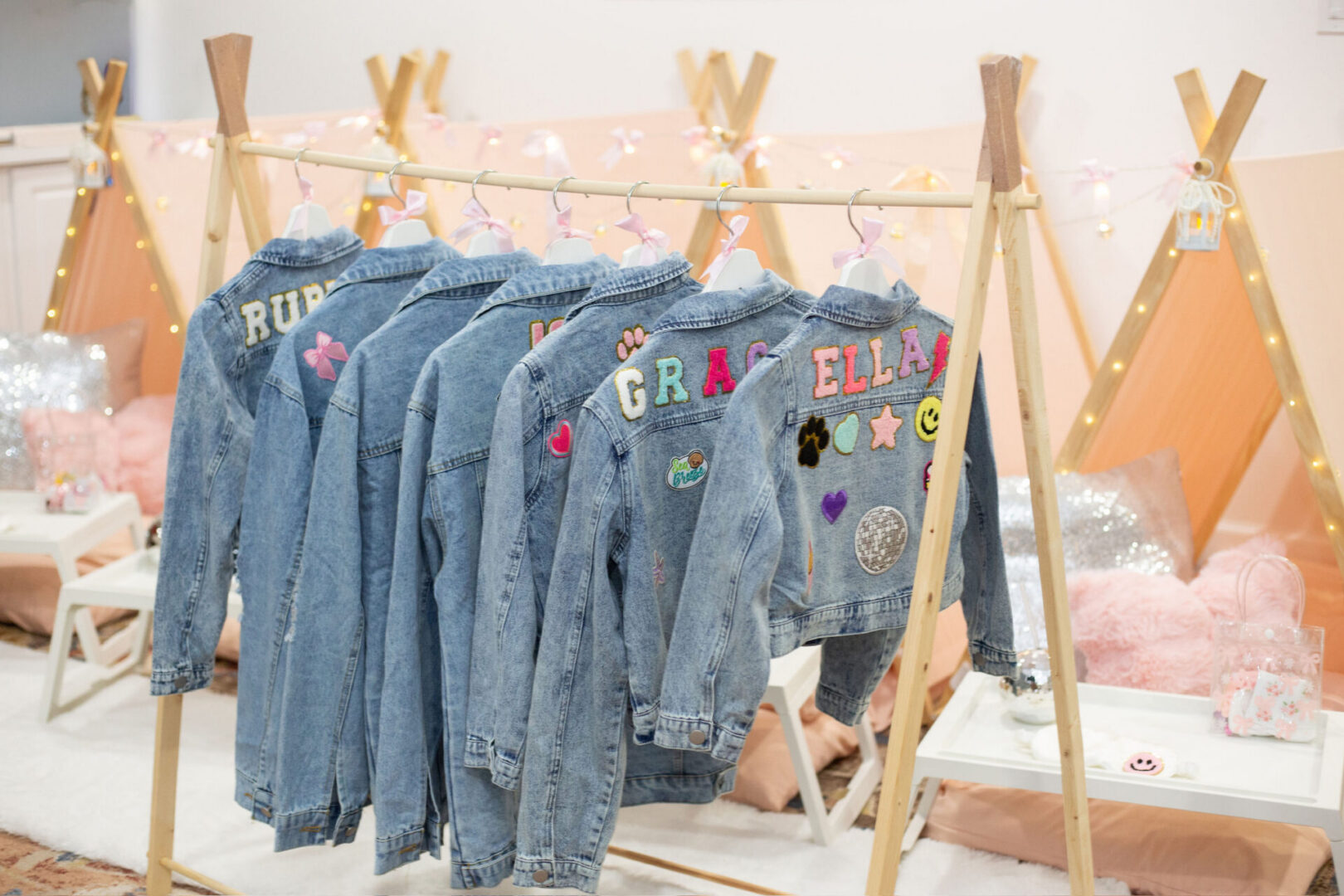 Denim jackets with personalized embroidery hanging up.