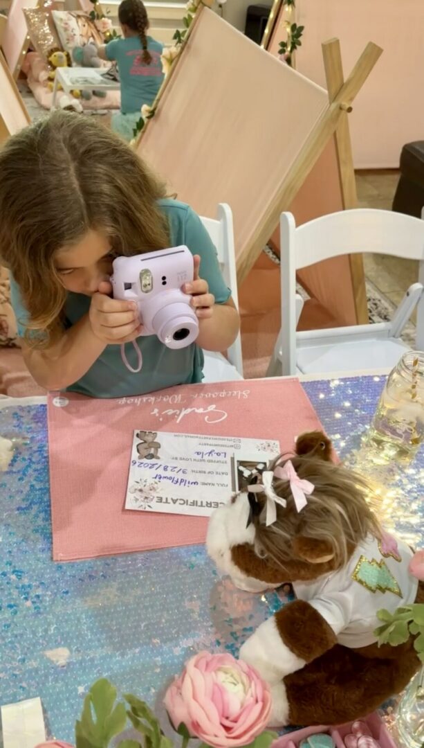Child takes photo at a colorful party.