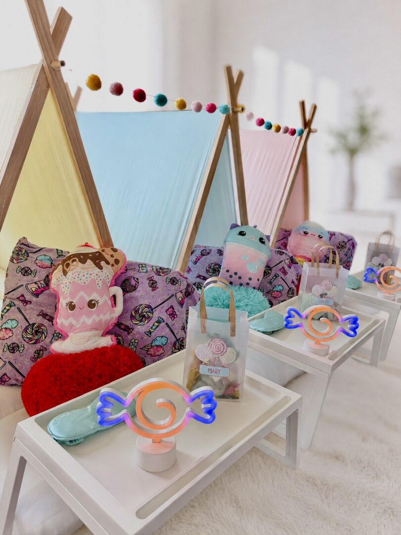 Colorful indoor tents with pillows and treats.