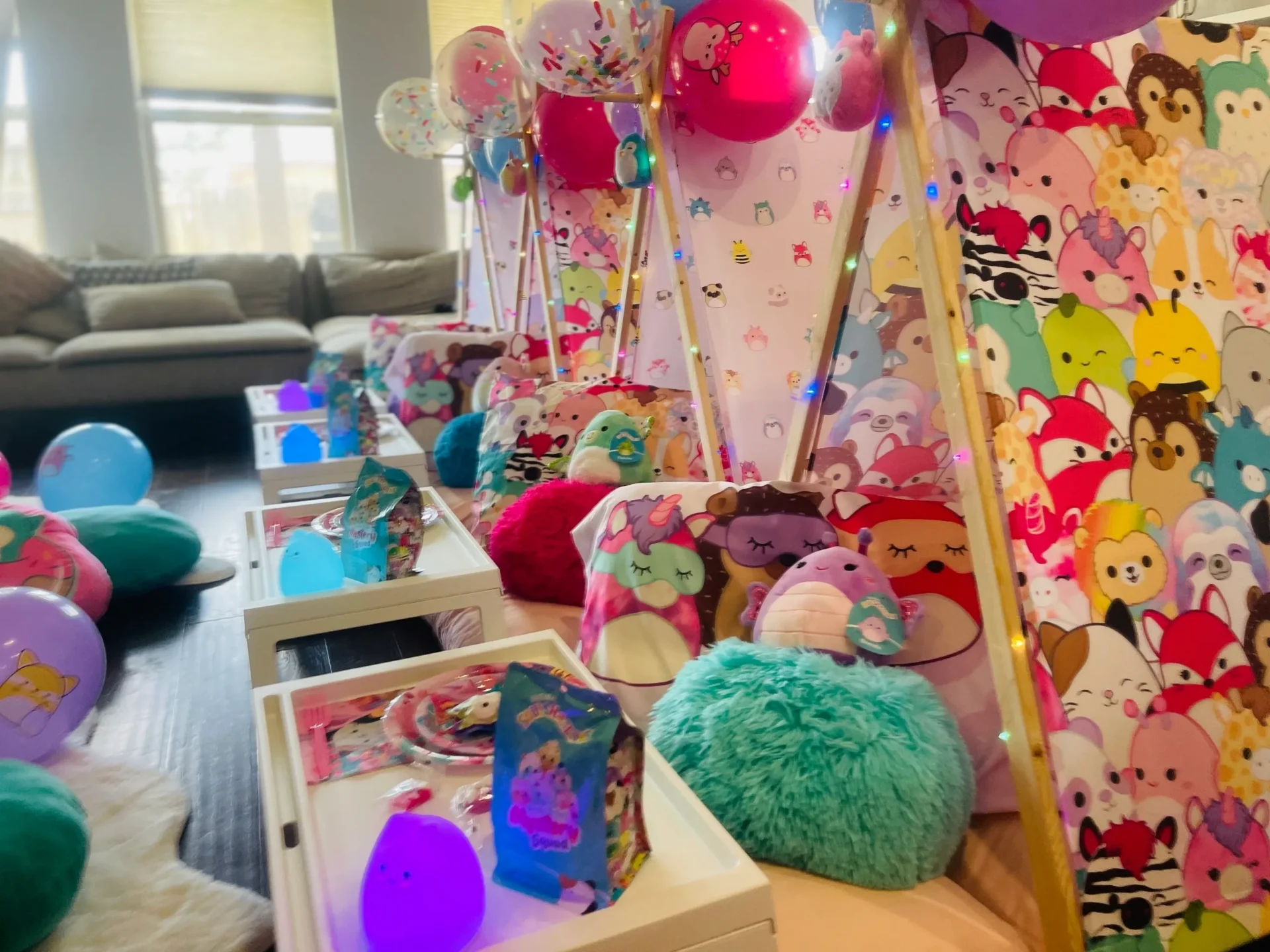 Colorful sleepover tents with plush toys and balloons.