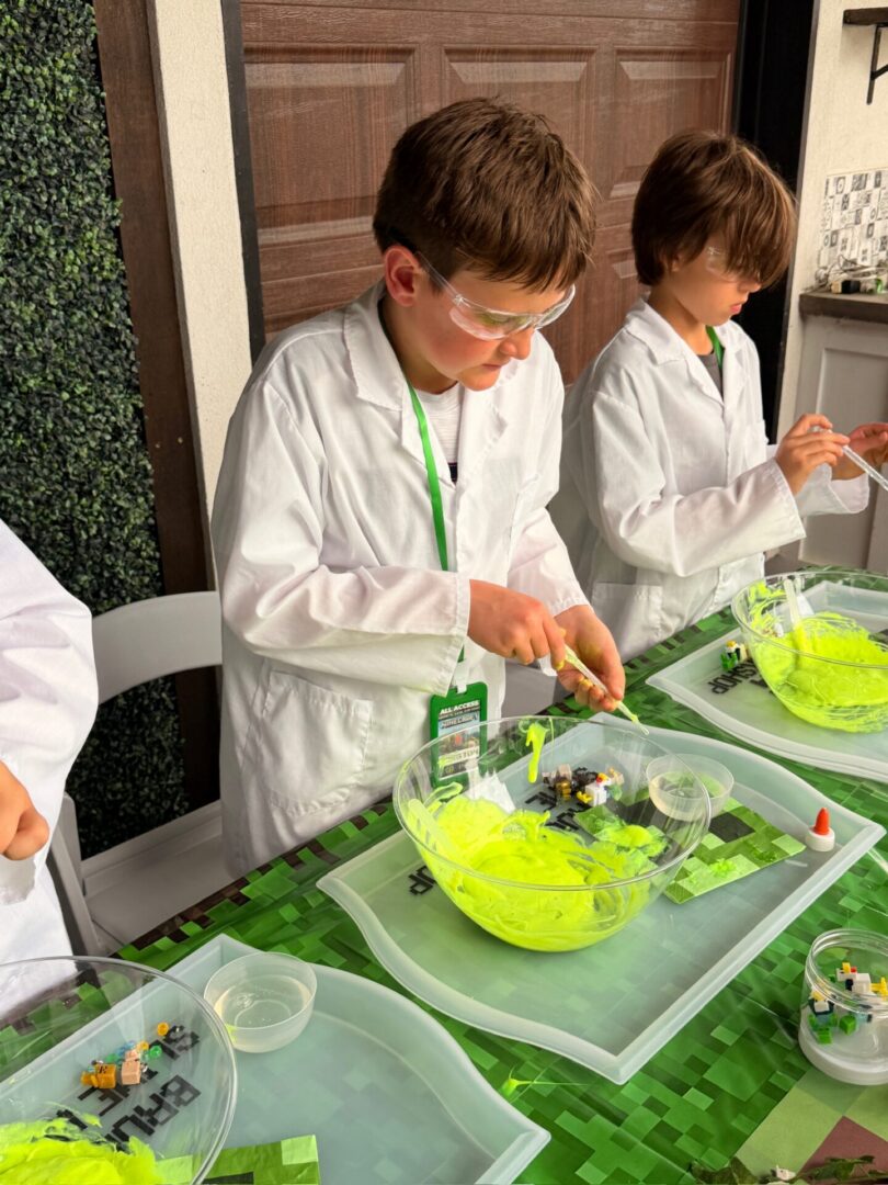 Kids in lab coats making slime.