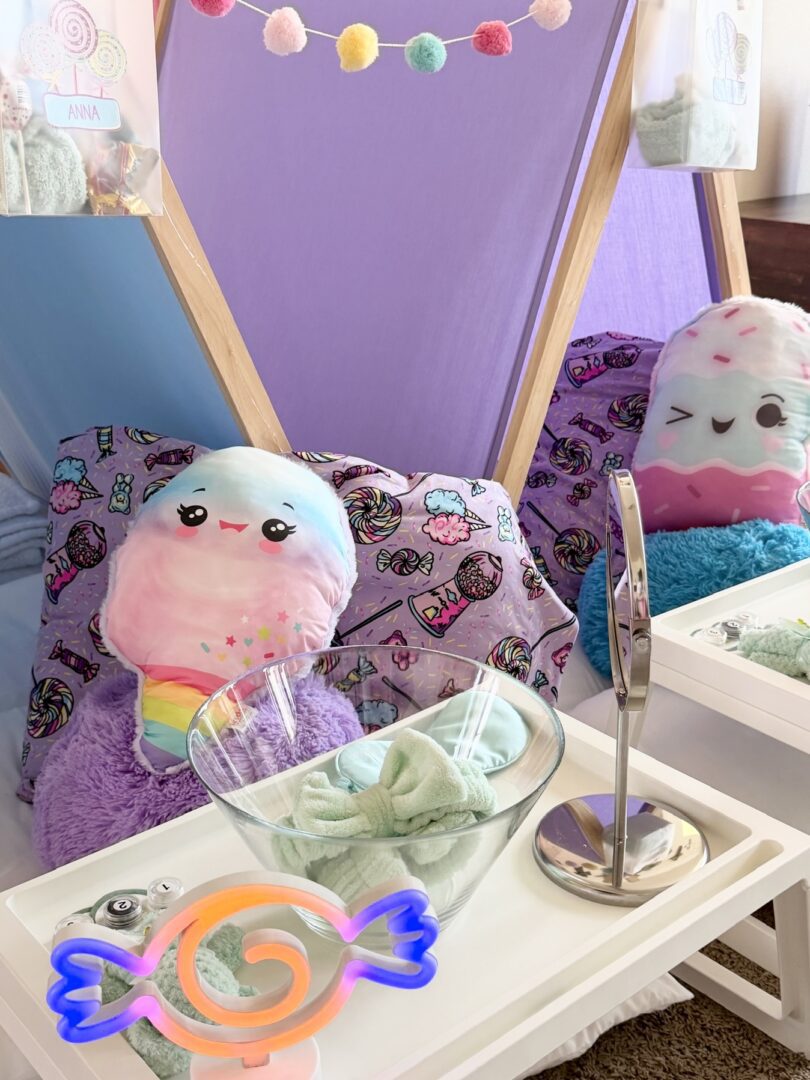 Colorful plushies in a cozy tent setup.