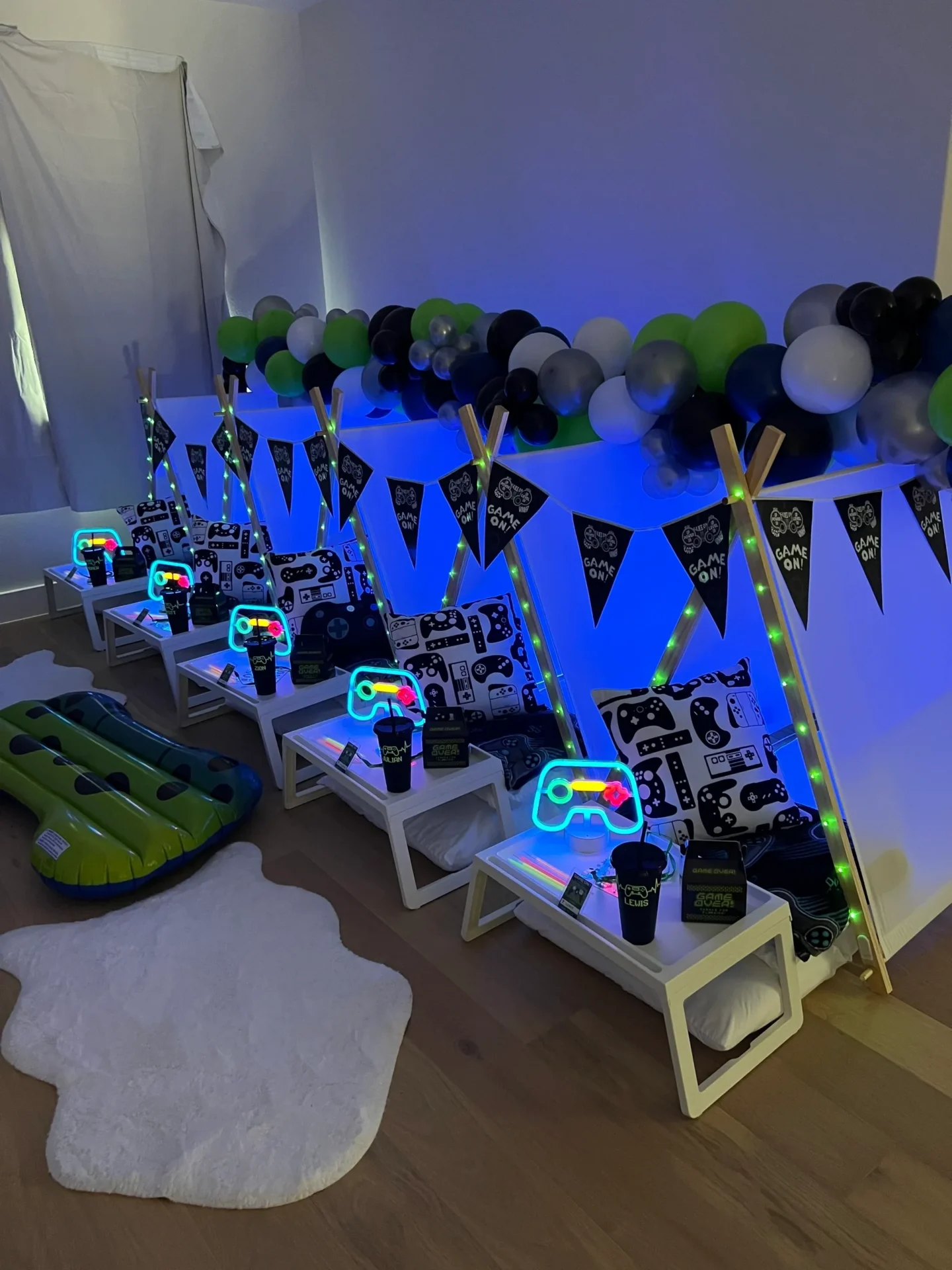 Gaming-themed sleepover setup with neon lights.