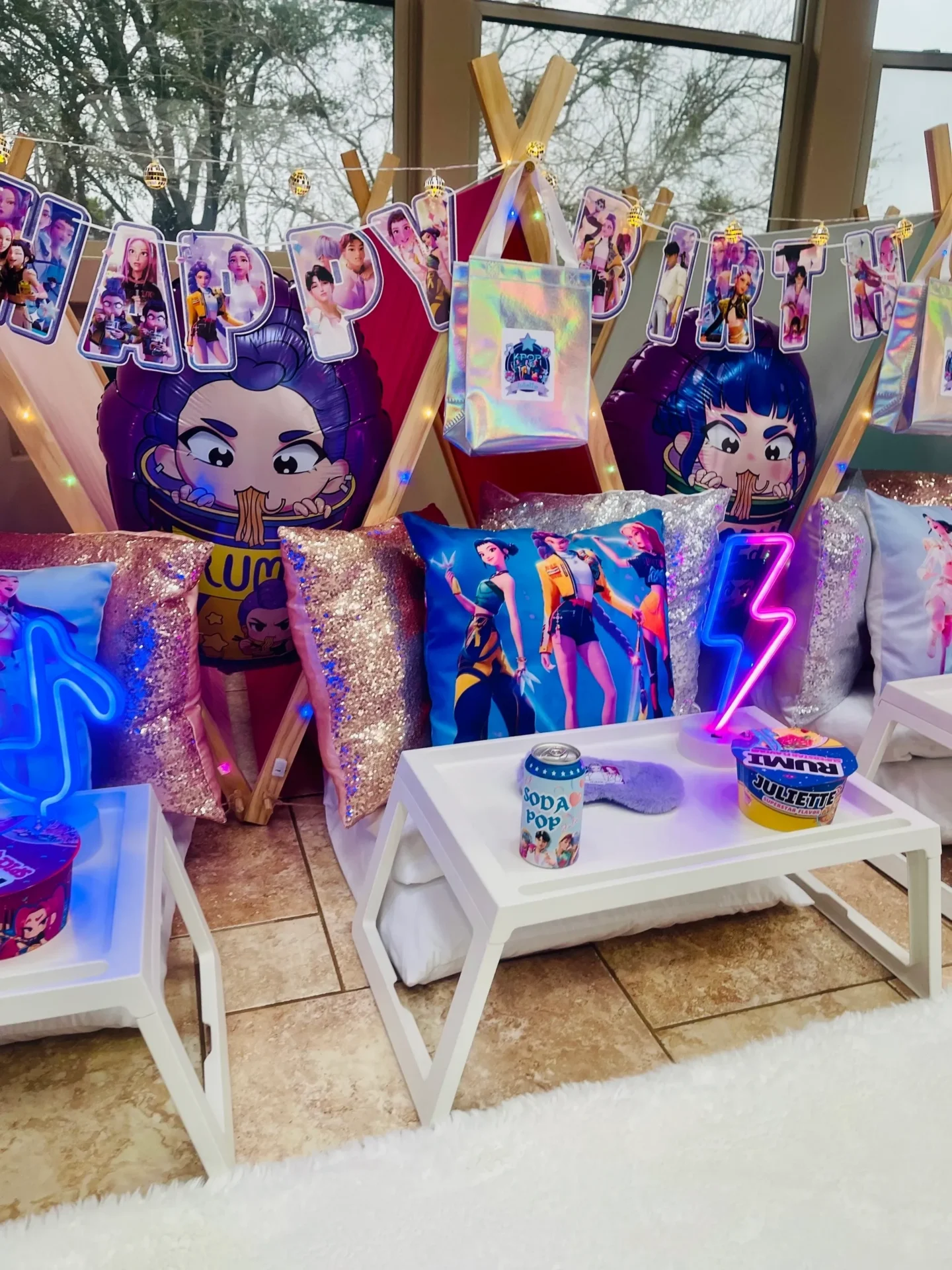 Colorful party setup with pillows and decorations.