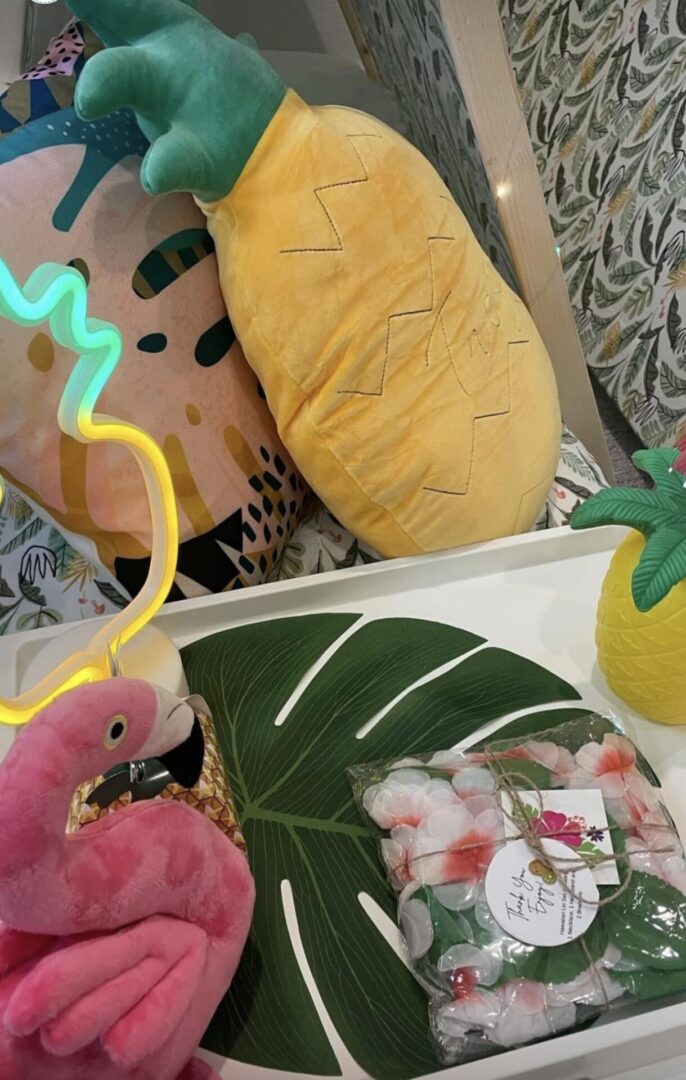 Tropical-themed decor with pineapple and flamingo.