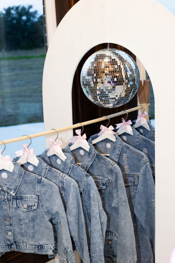 Denim jackets hanging under disco ball.