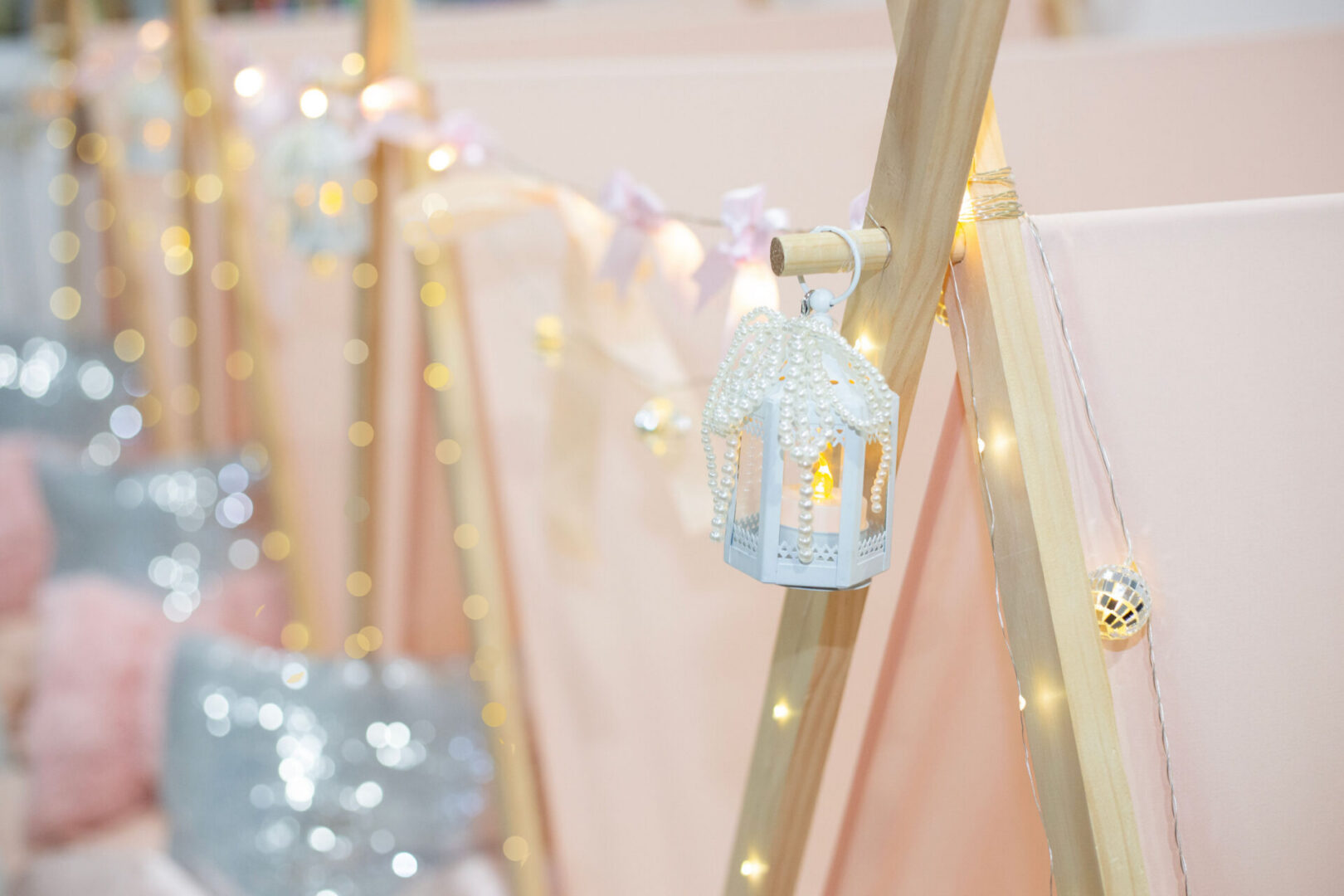 Decorative lanterns on pink tent setup.