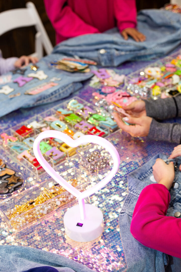Heart lamp and crafts on sequin table.