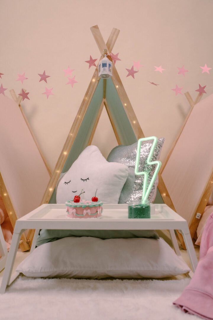 Cozy teepee with pillows and decorations.