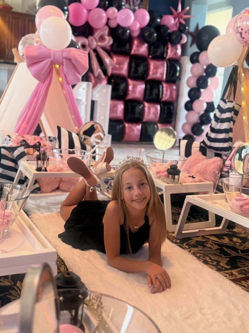 Girl at pink and black birthday party.