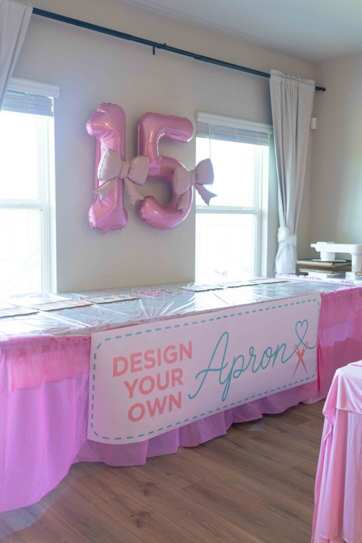 Pink birthday decor with apron design table.