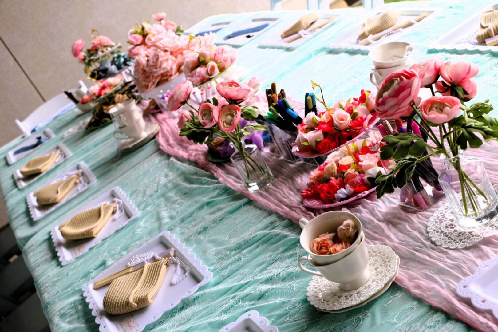 Elegant table setting with flowers and teacups.