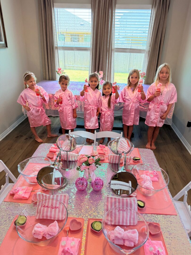 Girls in pink robes at spa party.