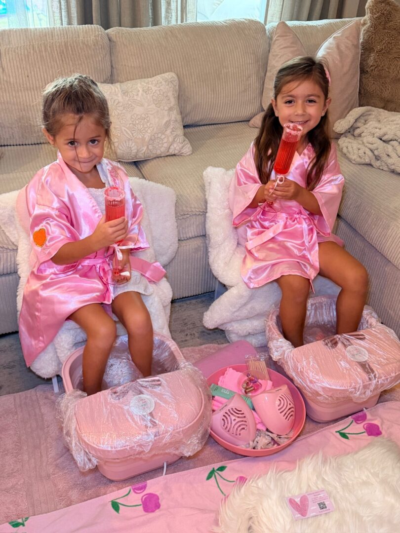 Girls in pink robes enjoying spa day.
