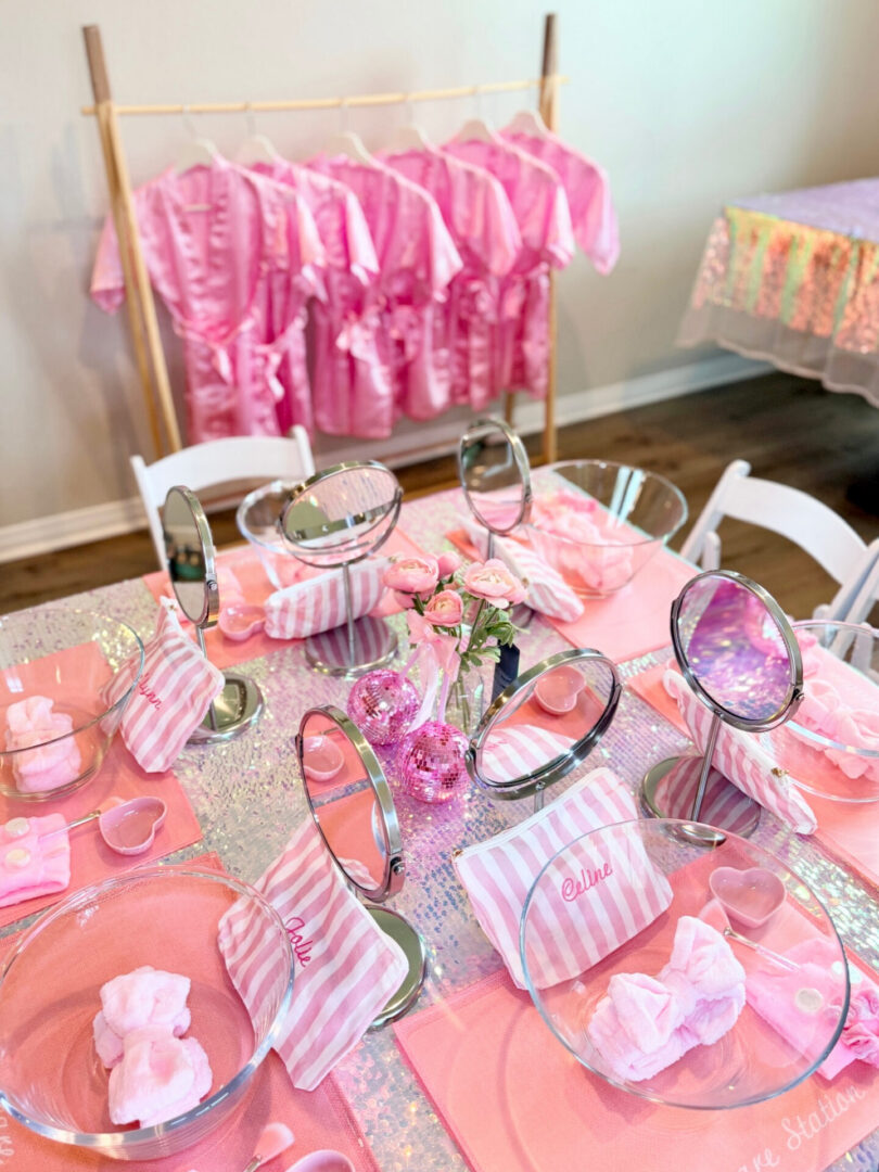 Pink-themed spa party table setting.