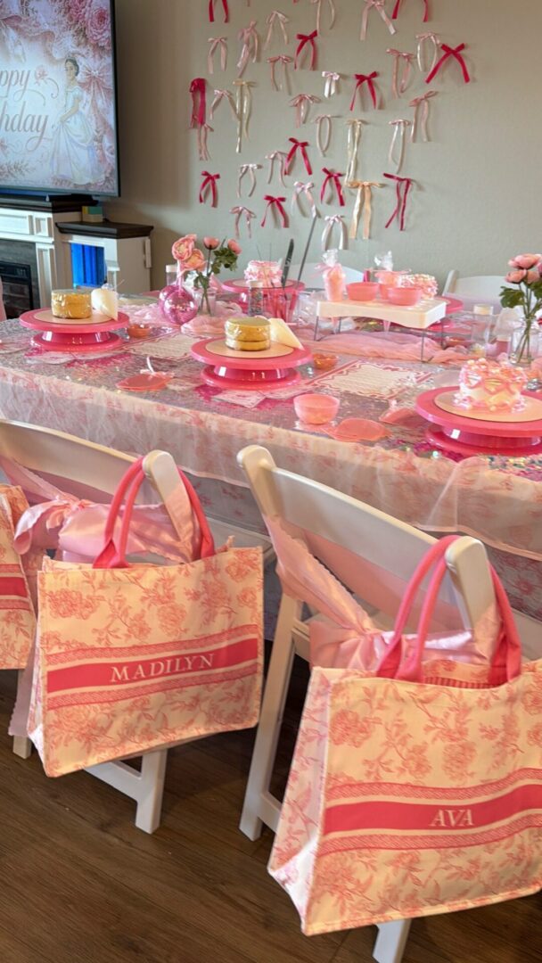 Pink-themed birthday party table setup.