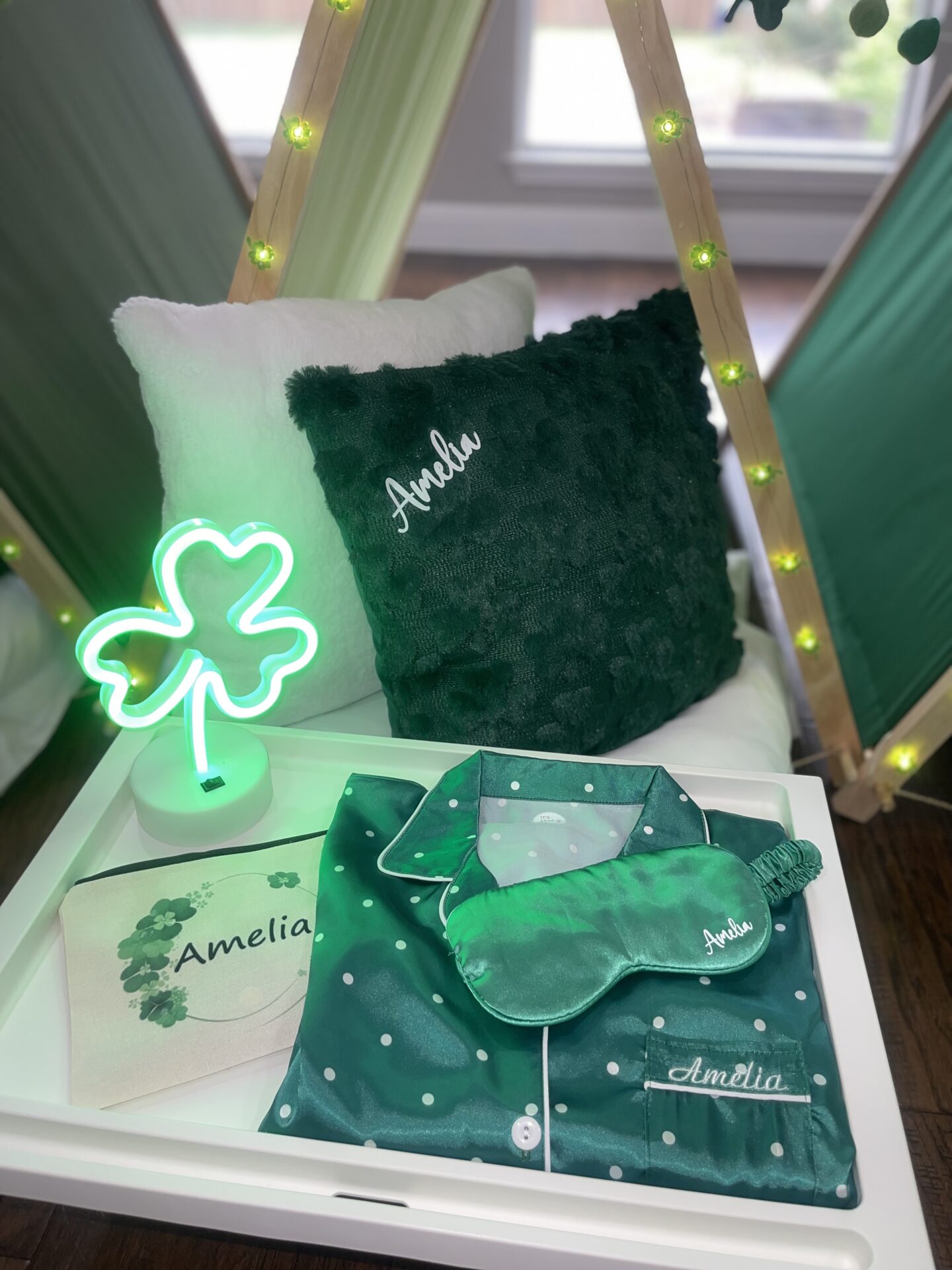 Green pajamas and pillows with personalized names.