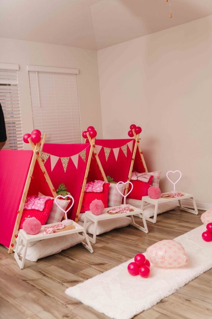 Pink indoor tents with festive decorations.