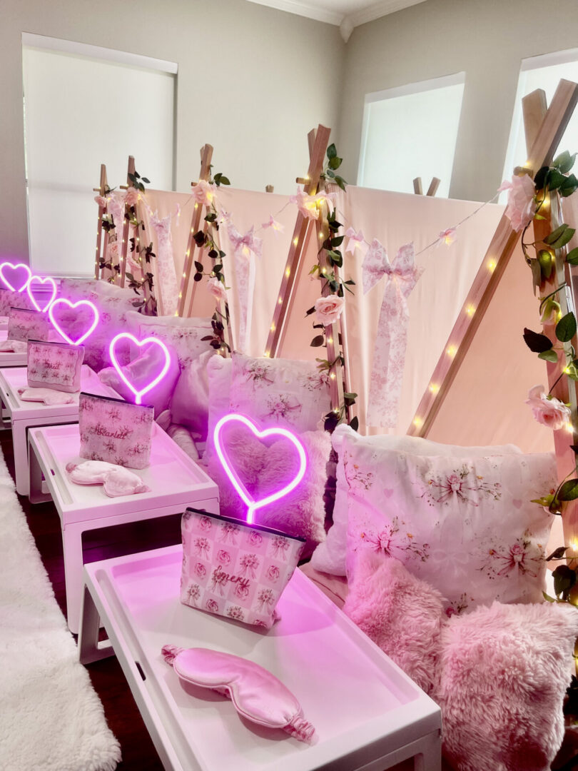 Pink-themed sleepover tents with heart lights.