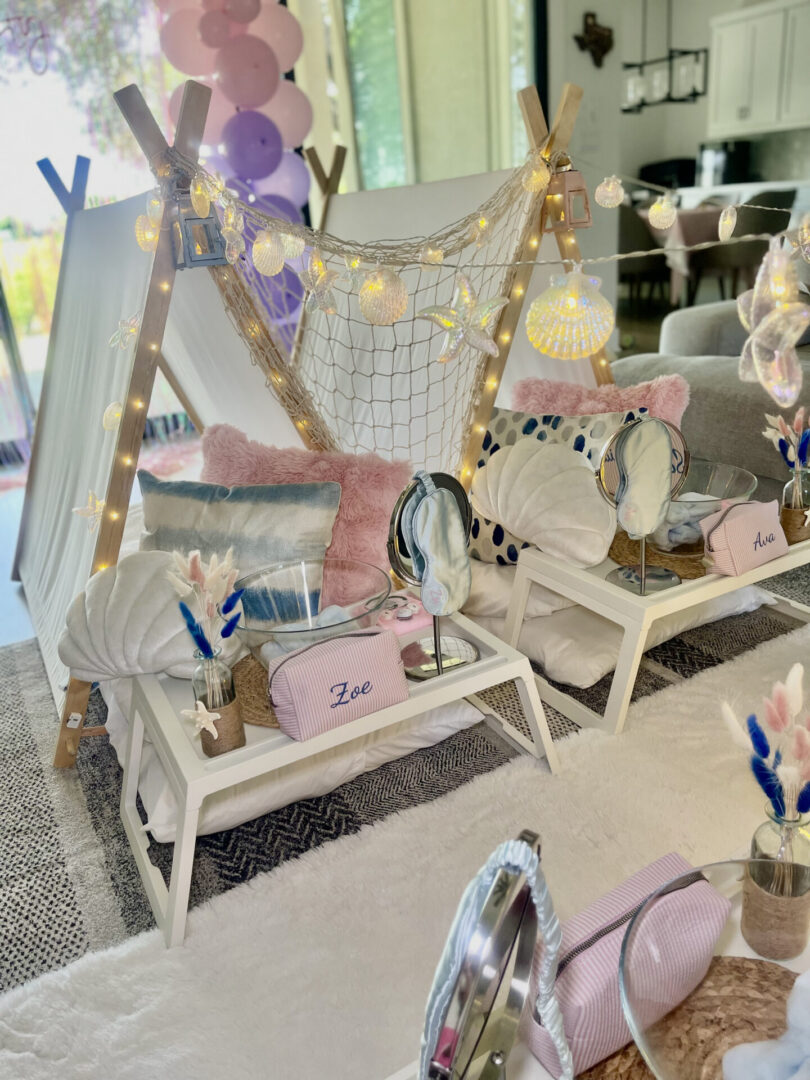 Indoor sleepover tents with pink decorations.