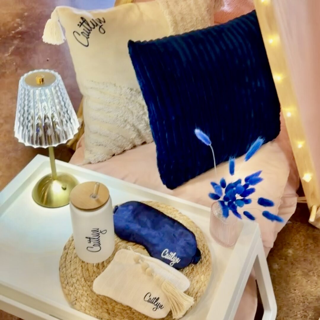 Cozy bedroom with decorative pillows and lamp.
